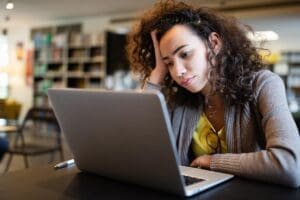 woman with head in hands considers the ocd and anxiety connection