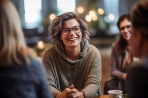 woman smiling talks with peers in treatment about tms therapy for depression