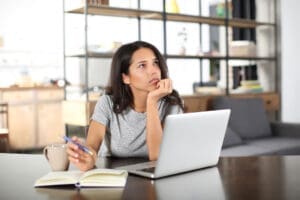 woman at laptop wonders what are intrusive thoughts