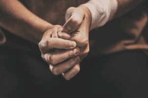Hands of a person finally talking about trauma