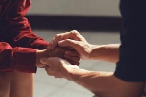 Hands of two people talking about how therapy can help with anxiety