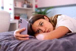 Person experiencing the link between being on social media and depression