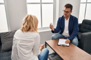 doctor and patient discuss whether medication, therapy, or a combination is better to treat mental health